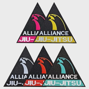 Puede incluir: Cinco parches triangulares bordados con fondo negro. Cada uno presenta un icono de cabeza de ave estilizada sobre el texto blanco ALLIANCE y JIU-JITSU. Los iconos de aves y las barras de texto inferiores son de color rosa, amarillo, blanco, naranja y verde azulado.