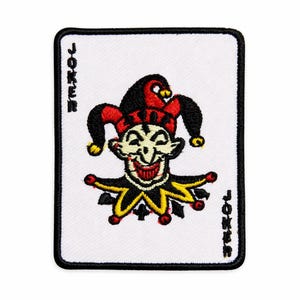 May include: Embroidered patch featuring a smiling joker character from a deck of cards. The patch has a white background with a black border. The joker is depicted in red, black, and yellow, with the word "JOKER" printed on the sides.