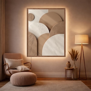 Könnte beinhalten: Gerahmtes abstraktes Wandkunstwerk mit warmer, neutraler Farbpalette. Das Kunstwerk zeigt geschichtete, halbkreisförmige Formen in Beige-, Braun- und Weißtönen mit strukturiertem Finish. Der Rahmen hat eine eingebaute Beleuchtung.