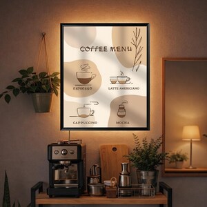May include: A framed coffee menu with a black border, featuring illustrations of espresso, latte americano, cappuccino, and mocha. The text "Coffee Menu" is at the top. The background has beige and white shapes. A coffee machine and plants are in the foreground.