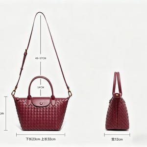 May include: A burgundy woven leather handbag with two top handles and a detachable shoulder strap. The bag features a flap closure with a snap button. Dimensions are 18.5 cm high, 23 cm bottom length, 32 cm top length, 12 cm wide, 14 cm handle drop, and 49-57 cm strap drop.