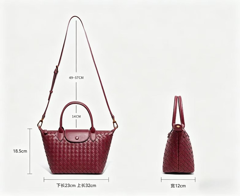 May include: A burgundy woven leather handbag with two top handles and a detachable shoulder strap. The bag features a flap closure with a snap button. Dimensions are 18.5 cm high, 23 cm bottom length, 32 cm top length, 12 cm wide, 14 cm handle drop, and 49-57 cm strap drop.