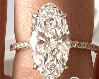 May include: A close-up of a rose gold ring featuring a large, oval-cut diamond as the centerpiece. The band is encrusted with smaller diamonds. The IGI logo is visible in the bottom right corner.