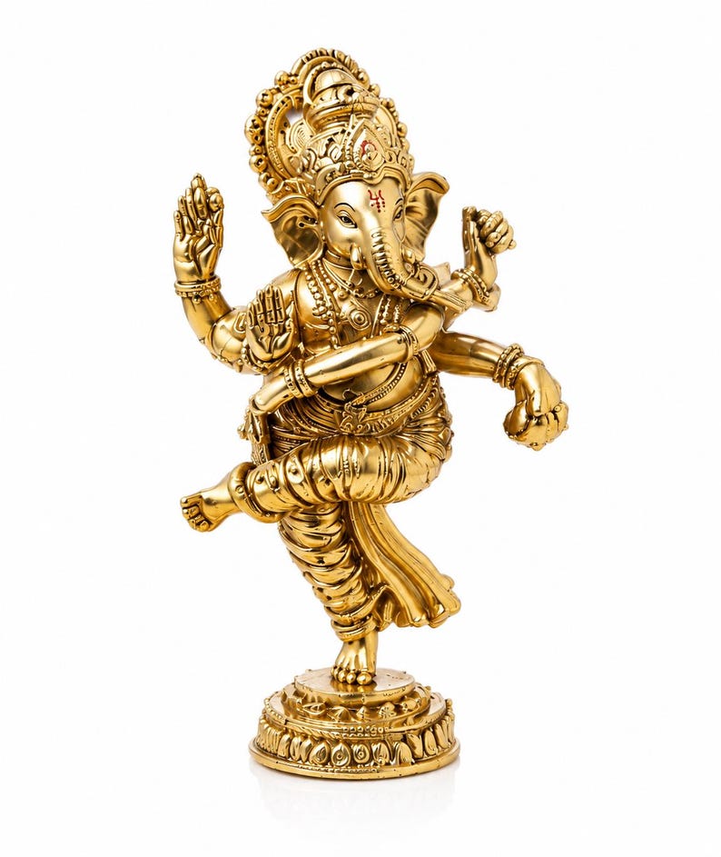 May include: A gold-colored statue of the Hindu deity Ganesha, depicted in a dynamic dancing pose. The statue features intricate details, including ornate jewelry, a large headdress, and multiple arms. The figure stands on a detailed circular base.