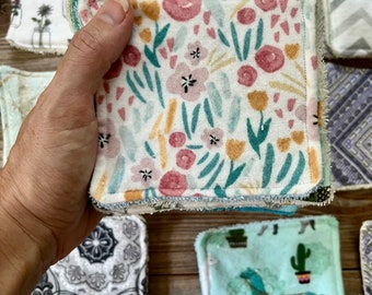 May include: A stack of reusable makeup remover pads with various floral and geometric patterns. The pads are made of soft, absorbent fabric and are perfect for removing makeup and cleansing the skin.
