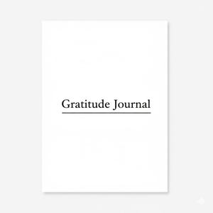 Peut inclure: Un journal blanc avec les mots "Gratitude Journal" en noir, dans une police élégante. Le texte est centré et souligné. Le journal est rectangulaire et semble être vierge à l'intérieur.
