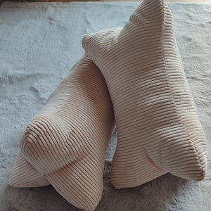 May include: A white ceramic mug with a black handle and the text "But First, Coffee" in a black, handwritten-style font. The mug is on a white surface.