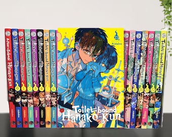 May include: A collection of manga volumes titled "Toilet-bound Hanako-kun" and "After-School Hanako-kun." The spines are colorful, with the series title and volume numbers visible. The central volume features a vibrant illustration of two characters.