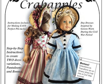 May include: A sewing pattern for two 18-inch doll dresses inspired by Civil War gowns. The pattern includes instructions for making two dress variations, pantaloons, and a bonnet. The pattern is titled "Stand By Me" and is designed by Crabapples.
