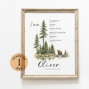May include: A framed art print with a forest scene illustration, featuring trees and a bear. The print includes the words "I am" and inspirational phrases, plus the name "Oliver" and a baptism date. A sticker says "ready in 1 day".