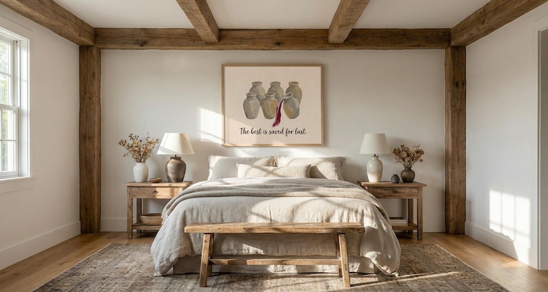 May include: A rectangular wall art print in a light wood frame featuring five beige ceramic jugs, with a dark red liquid pouring from the center jug into the one in front. The text below reads, The best is saved for last. The print is centered.