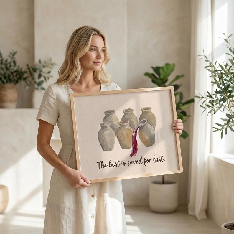May include: A rectangular framed print featuring a beige background with an illustration of six light brown ceramic jugs. One jug is tilted, pouring dark red liquid. The text "The best is saved for last." is printed in black below the jugs.