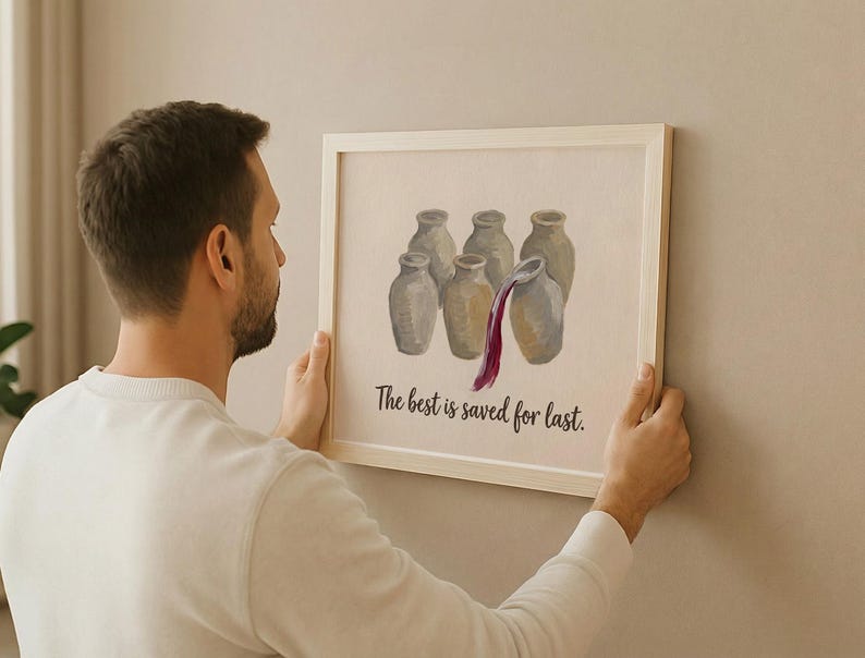 May include: A framed wall art print featuring a light-colored background with an illustration of six beige ceramic jars. One jar is pouring out a stream of dark red liquid. Below the jars, the text reads, The best is saved for last.