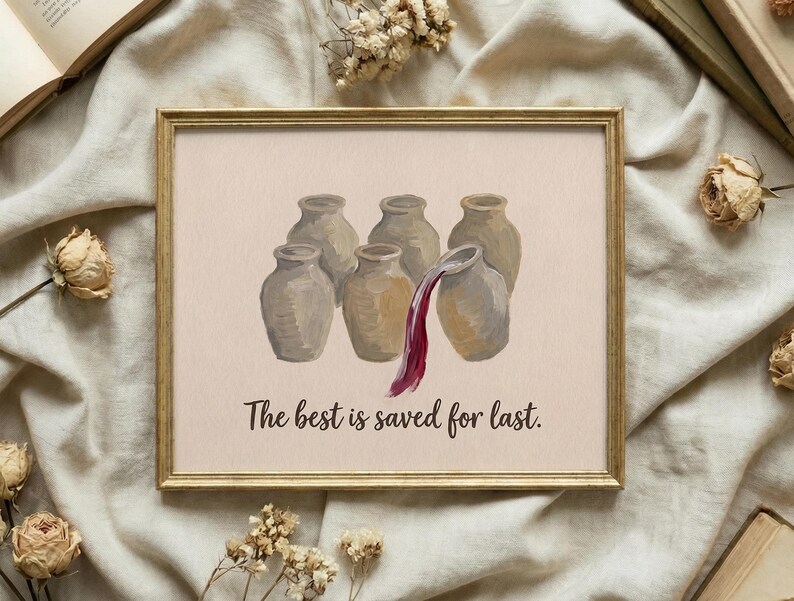 May include: A framed print featuring six beige ceramic jars arranged in a group. One jar on the right is tilted, pouring out a stream of deep red liquid. Below the jars, the text reads, "The best is saved for last." in a dark brown script font.
