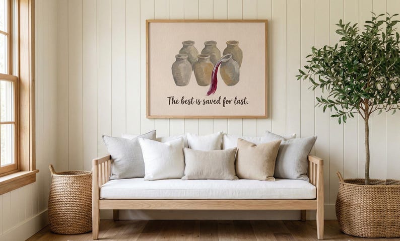 May include: A rectangular wall art print in a light wood frame featuring a beige background with six gray ceramic jars. One jar is pouring dark red liquid. The text "The best is saved for last." is printed in black below the jars.