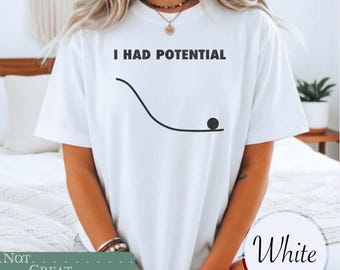 May include: A white short-sleeved t-shirt featuring the black text I HAD POTENTIAL printed above a black graphic of a curved line representing a slope with a small black circle positioned at the bottom end of the curve on the front of the shirt.