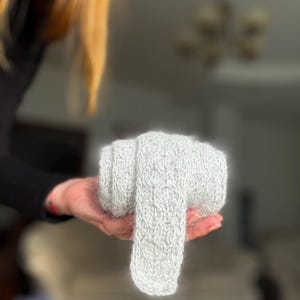 May include: A set of three ceramic mugs with a speckled, matte finish. The mugs are in shades of cream, light gray, and dark gray. Each mug has a simple, minimalist design and a rounded handle.