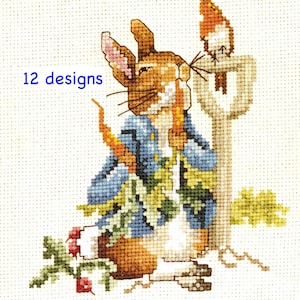 May include: A cross-stitch pattern featuring a brown rabbit wearing a blue jacket, holding a carrot, and standing next to a garden tool. The design includes green foliage, red radishes, and the blue text 12 designs on a white grid fabric.