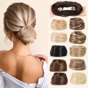 May include: A collection of synthetic hair bun extensions in various shades, including blonde, brown, black, and highlighted tones. The hair pieces are circular, textured, and designed to be worn as a hair accessory to create a full, voluminous bun.