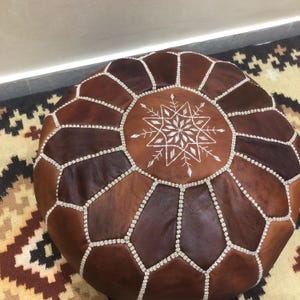 Side view of handmade leather pouf.