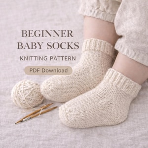 May include: Cream-coloured knitted baby socks with the text "BEGINNER BABY SOCKS KNITTING PATTERN PDF Download". A ball of yarn and knitting needles are next to the socks. The socks are on a baby's feet.