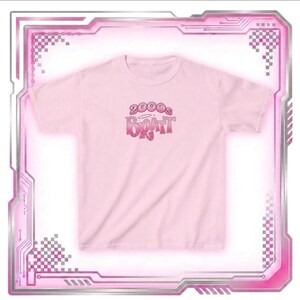 May include: A light pink t-shirt with the text "2000s Bratz" in a gradient pink and red font. The shirt is short-sleeved and has a crew neck. The design is centered on the front of the shirt.