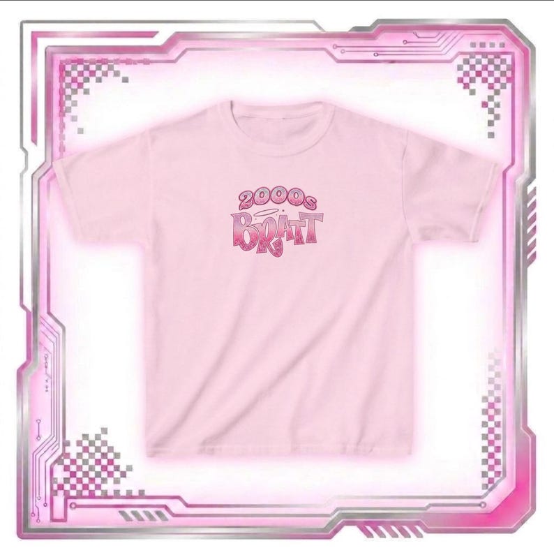 May include: A light pink t-shirt with the text "2000s Bratz" in a gradient pink and red font. The shirt is short-sleeved and has a crew neck. The design is centered on the front of the shirt.