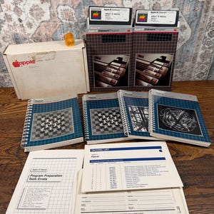 May include: A collection of Apple III Pascal software including two diskettes in boxes, four spiral-bound manuals with graphic covers, a Program Preparation Tools Errata sheet, and a packing list with a blank Apple product report form.