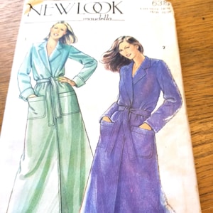 May include: A vintage New Look sewing pattern featuring illustrations of long robes with pockets and belts. The robes are depicted in shades of blue and purple. The pattern is labeled "6315" and "maudella".