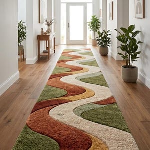 May include: A long, patterned hallway rug with a wavy design in shades of green, rust, cream, and yellow. The rug is laid in a hallway with wooden flooring and potted plants, creating a warm, inviting atmosphere.