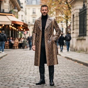 May include: A long, double-breasted trench coat featuring a brown and black snakeskin pattern, worn over a black turtleneck sweater and black trousers. The coat has wide lapels, long sleeves, and a matching belt tied at the waist, paired with black boots.