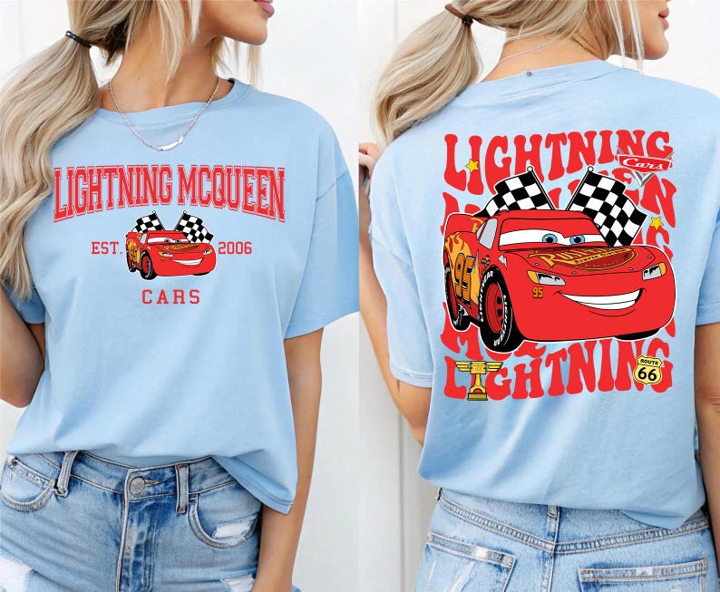 May include: Light blue t-shirt featuring Lightning McQueen graphics. The front design includes the text "Lightning McQueen Cars Est. 2006" with a red car and checkered flags. The back design showcases a larger image of the red car with checkered flags and the text "Lightning Cars".