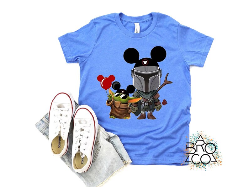 May include: A white ceramic mug with a black handle and the text "But First, Coffee" in a bold, black font. The mug is set against a blurred background, highlighting its clean design.