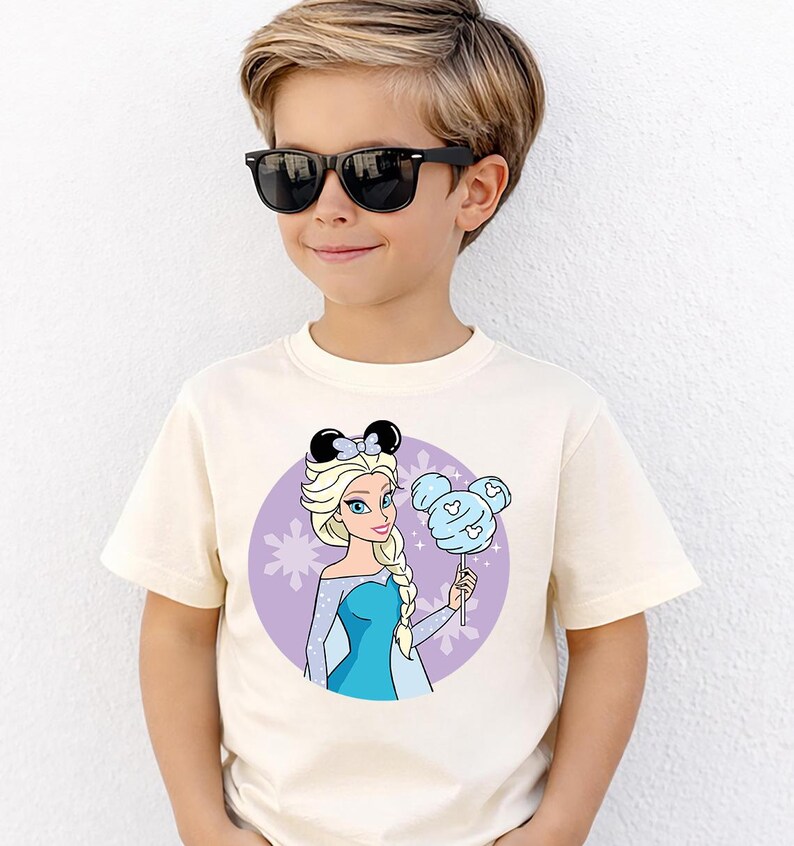 May include: A white ceramic mug with a black handle and the text "But First, Coffee" in a black, bold font. The mug is on a white surface.