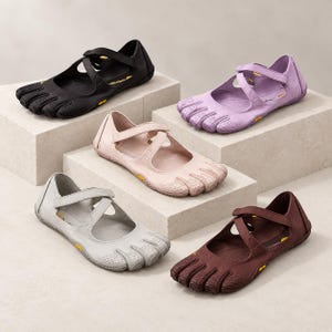 May include: Five individual toe shoes in black, lavender, light pink, light gray, and dark brown. Each shoe features a flexible sole, a textured toe area, and a crisscross strap closure across the top with a small yellow Vibram logo on the side.