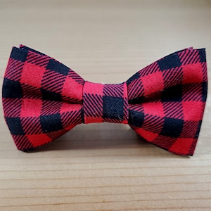 May include: A red and black plaid bow tie.