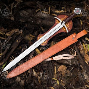 These iconic words engraved on the blade define this historic sword replica. The creed of the Knights Templar - Nothing for us, Lord, nothing for us but for the glory of thy name - marked their illustrious and sometimes infamous 200-year military influence. This magnificent sword named The Accolade would have been a sword worthy of the Grand Master to knight a loyal member into this holy order.
