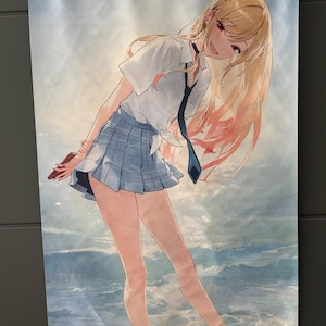May include: Anime wall scroll depicting a female character with long blonde hair, wearing a white collared shirt, blue plaid skirt, and a dark blue tie. The background shows a cloudy sky and ocean waves. The scroll is held by white rods.
