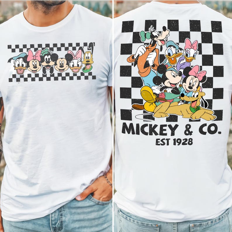 May include: A white t-shirt featuring a graphic of Disney characters on the front and back. The front shows a horizontal checkered strip with character faces. The back displays a large checkered square with characters and the text MICKEY & CO. EST 1928.