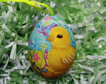 Easter Egg painted with a brightly coloured chick design, made from the shell of a real hen's egg