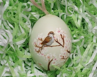 Sparrow Easter Egg. Painted eggshell ornament with a tiny painting of sparrows and branches of apple blossom, on a real egg shell.