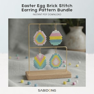 May include: An Easter Egg Brick Stitch Earring Pattern Bundle is displayed. The earrings are in the shape of Easter eggs, with colorful beadwork in pink, yellow, blue, and white. The earrings are displayed on a gold metal stand with a wooden base.