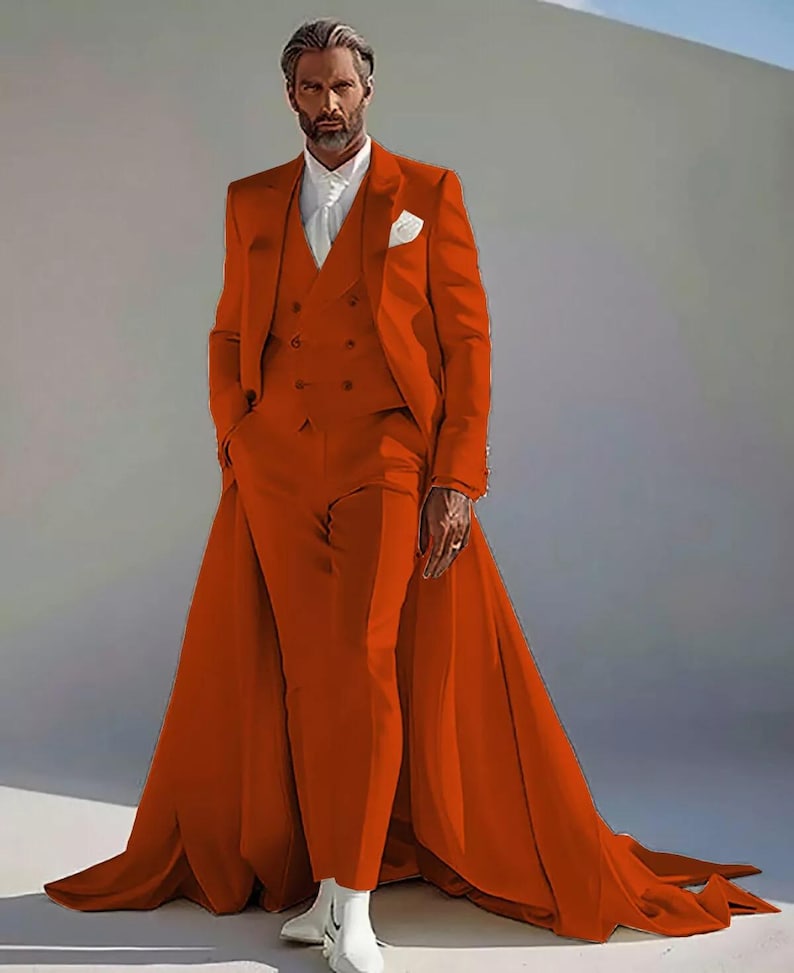 Puede incluir: Un llamativo traje naranja con una larga cola. El conjunto incluye una americana, un chaleco y un pantal&oacute;n. La persona lleva una camisa blanca y botas blancas. El traje es una audaz declaraci&oacute;n de moda.