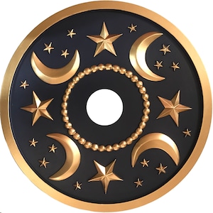 May include: A gold and black ceiling fan light cover with a design of stars and crescent moons.