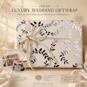 May include: A rectangular gift box wrapped in cream-colored paper with a black and silver vine pattern. The box is tied with a cream ribbon, a pearl bead, and a white wax seal. Text includes ADD ON LUXURY WEDDING GIFTWRAP and HINTUAN.CO.