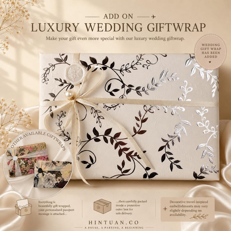 May include: A rectangular gift box wrapped in cream-colored paper with a black and silver vine pattern. The box is tied with a cream ribbon, a pearl bead, and a white wax seal. Text includes ADD ON LUXURY WEDDING GIFTWRAP and HINTUAN.CO.
