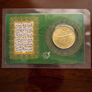 May include: A white ceramic mug with a black handle and the text "But First, Coffee" in a black, bold font. The mug is sitting on a wooden surface. The mug is approximately 4 inches tall.