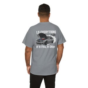 May include: Gray t-shirt with a graphic of a car with its hood open, engine visible, and smoke billowing from the tires. The text "LS EVERYTHING" is above the car, and "If It Fits, It Ships" is below.