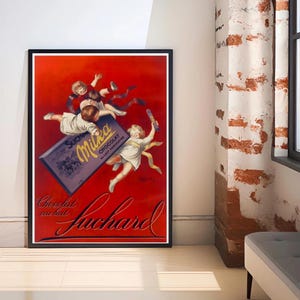 May include: Framed vintage advertisement for Milka chocolate. The poster features cherubic children reaching for a large chocolate bar and a chocolate stick against a red background. The words "Chocolat au lait Suchard" are written in elegant script.