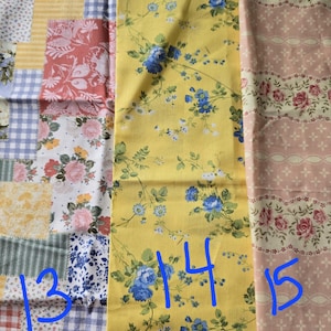 May include: Assortment of floral fabric swatches. One swatch features a patchwork design with various patterns. Another displays a yellow background with blue floral vines. The third swatch has a pink background with rose patterns.
